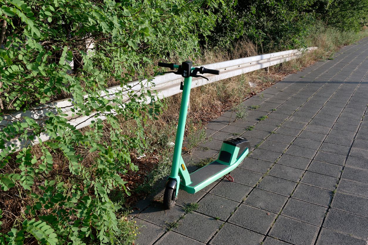 E-mobility single e-scooter on sidewalk abandoned