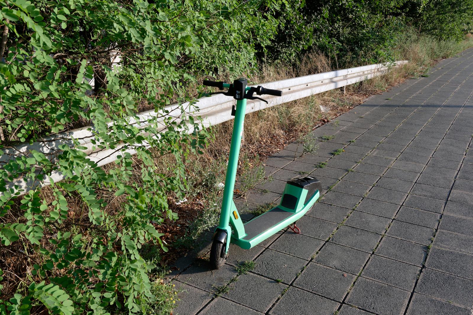 E-mobility single e-scooter on sidewalk abandoned