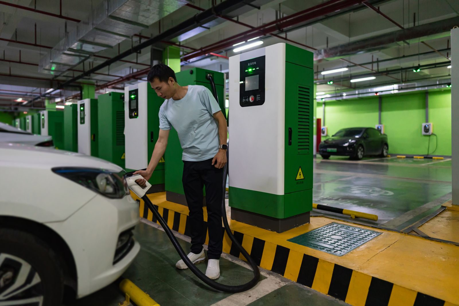 Man prepares to charge electric car