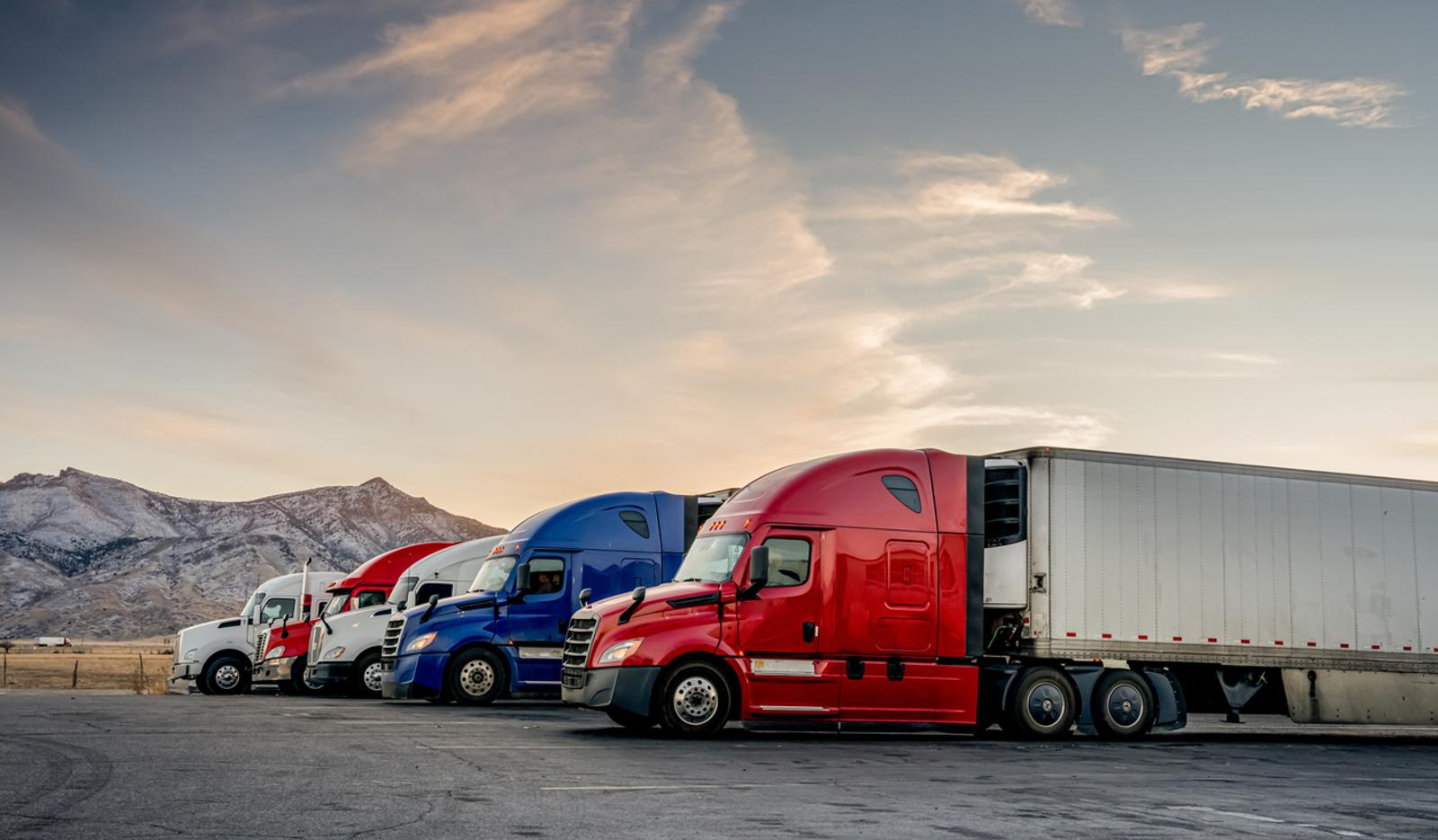 A fleet of trucks in parking lot