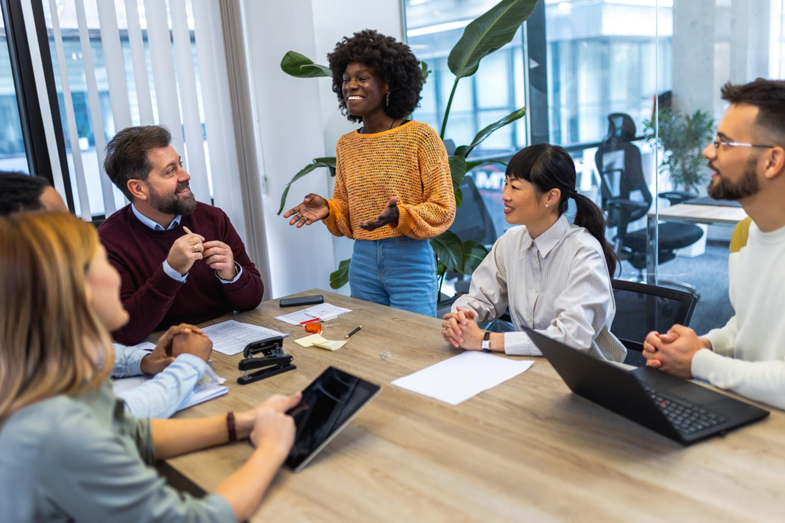 A group of employees collaborating around a conference room table
