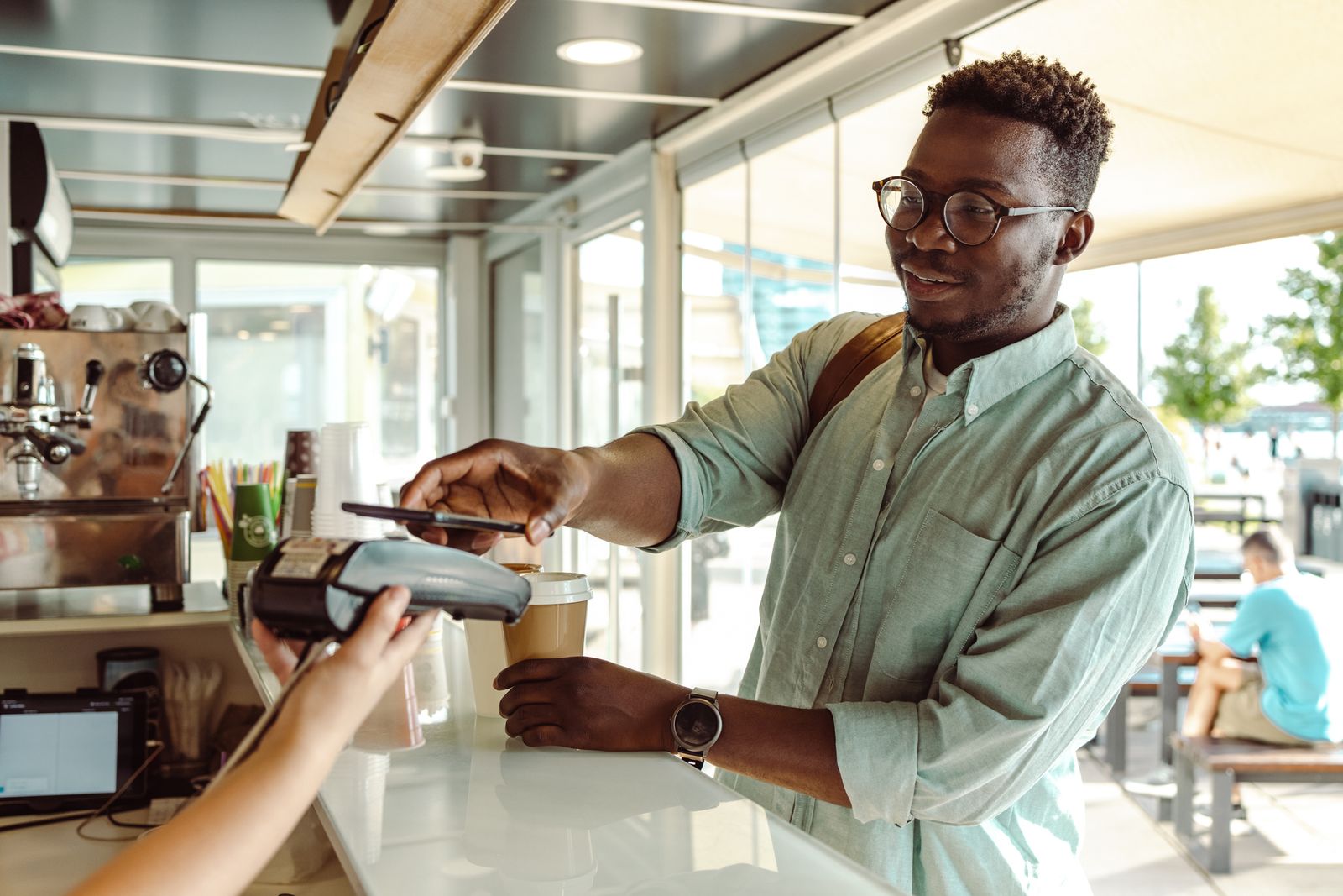 customer using a phone with a mobile pos to pay