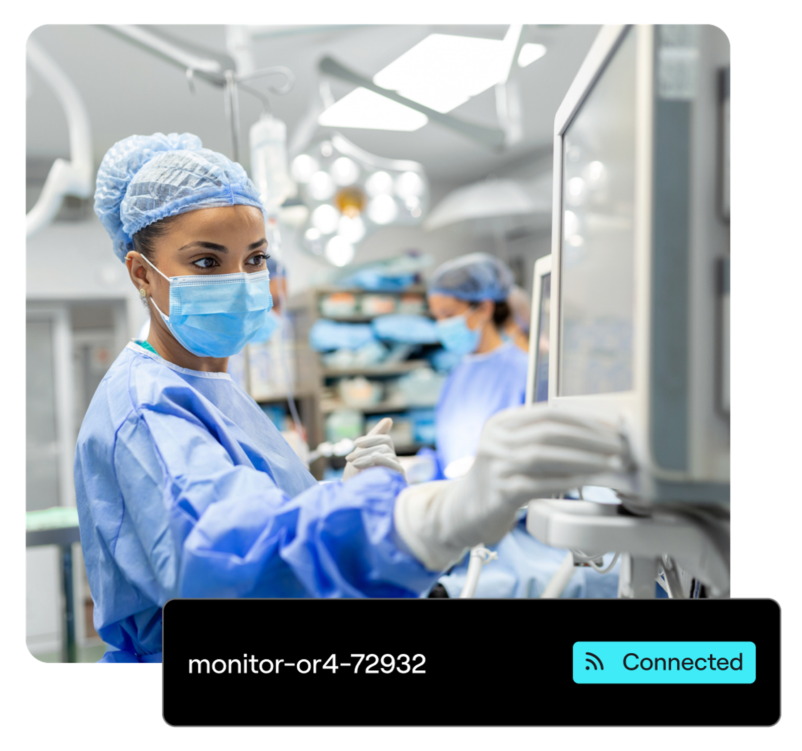 A surgeon touches a monitoring device in an emergency room