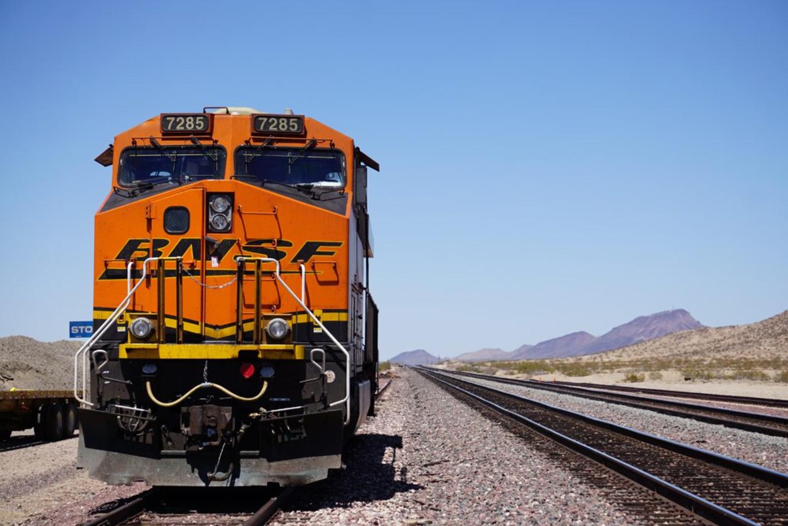 Train with mountains on horizon