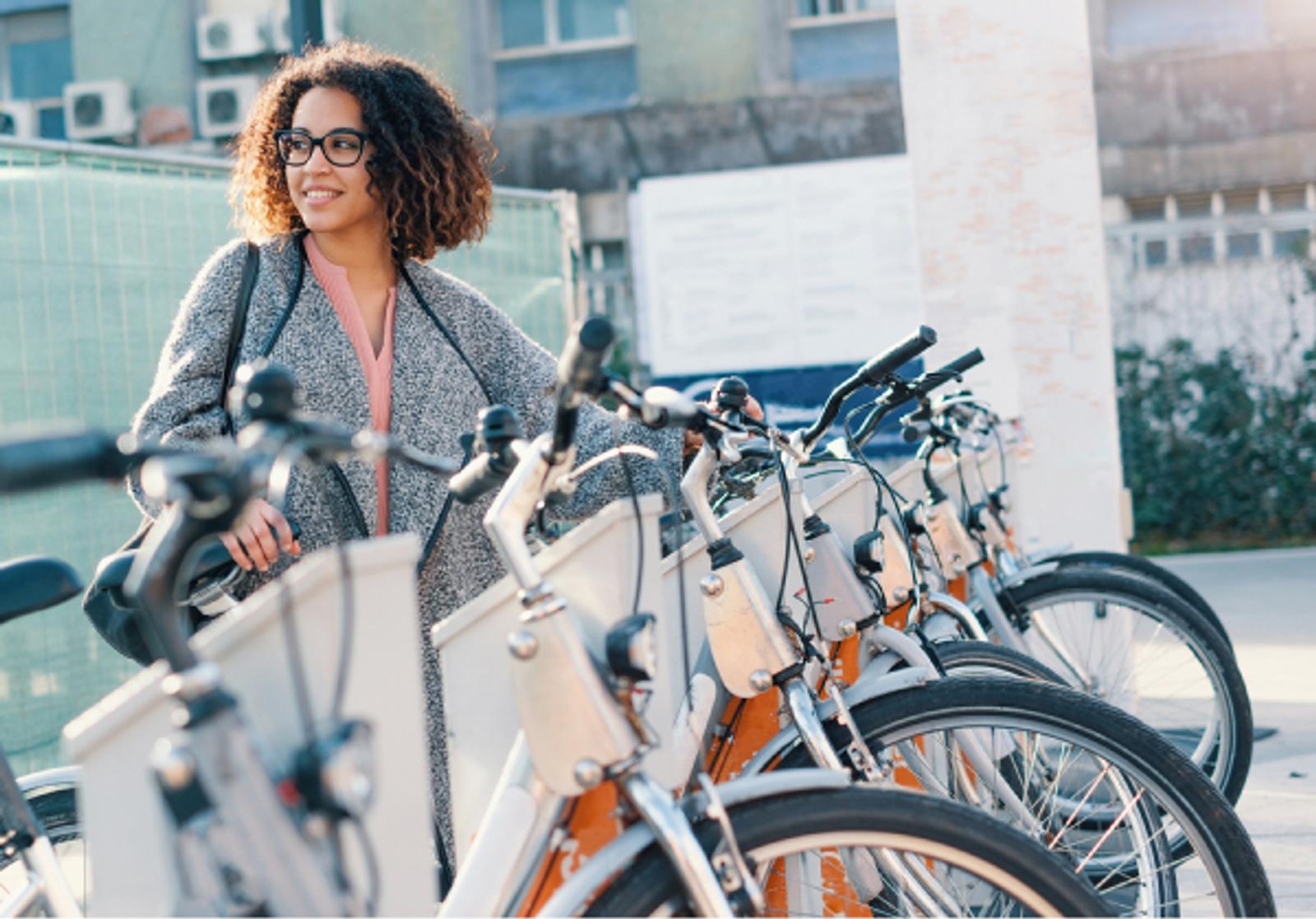 Woman standing by an electric bike station