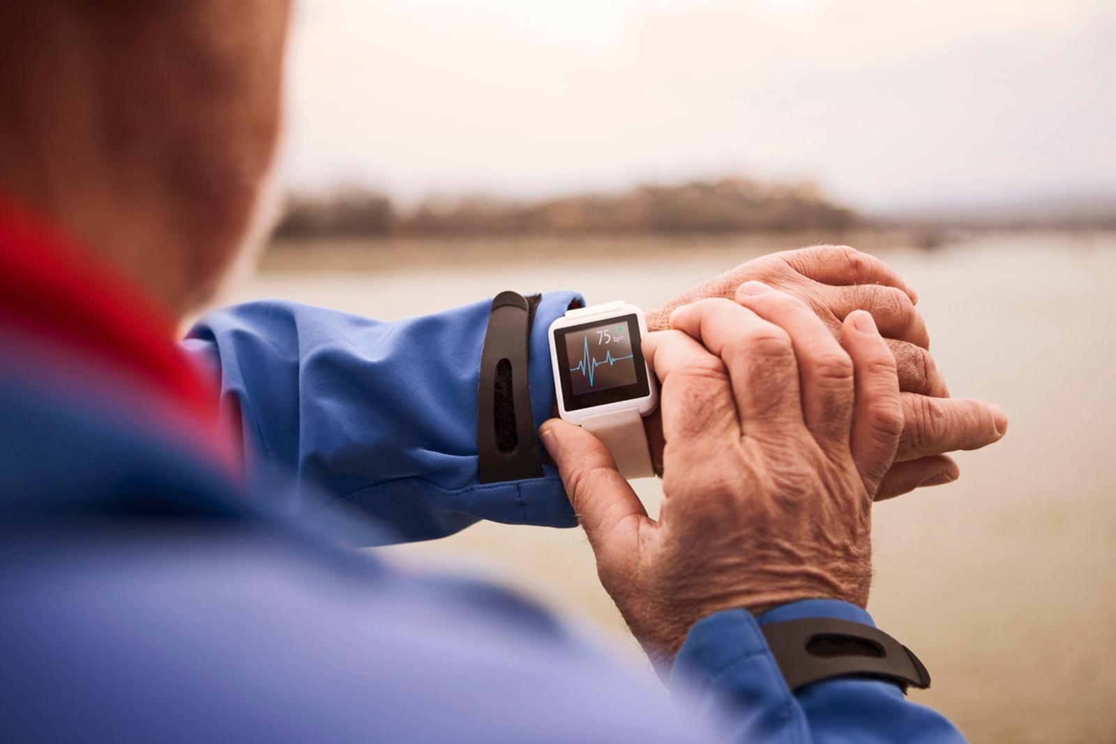 Senior Man using Smart Watch measuring heart rate