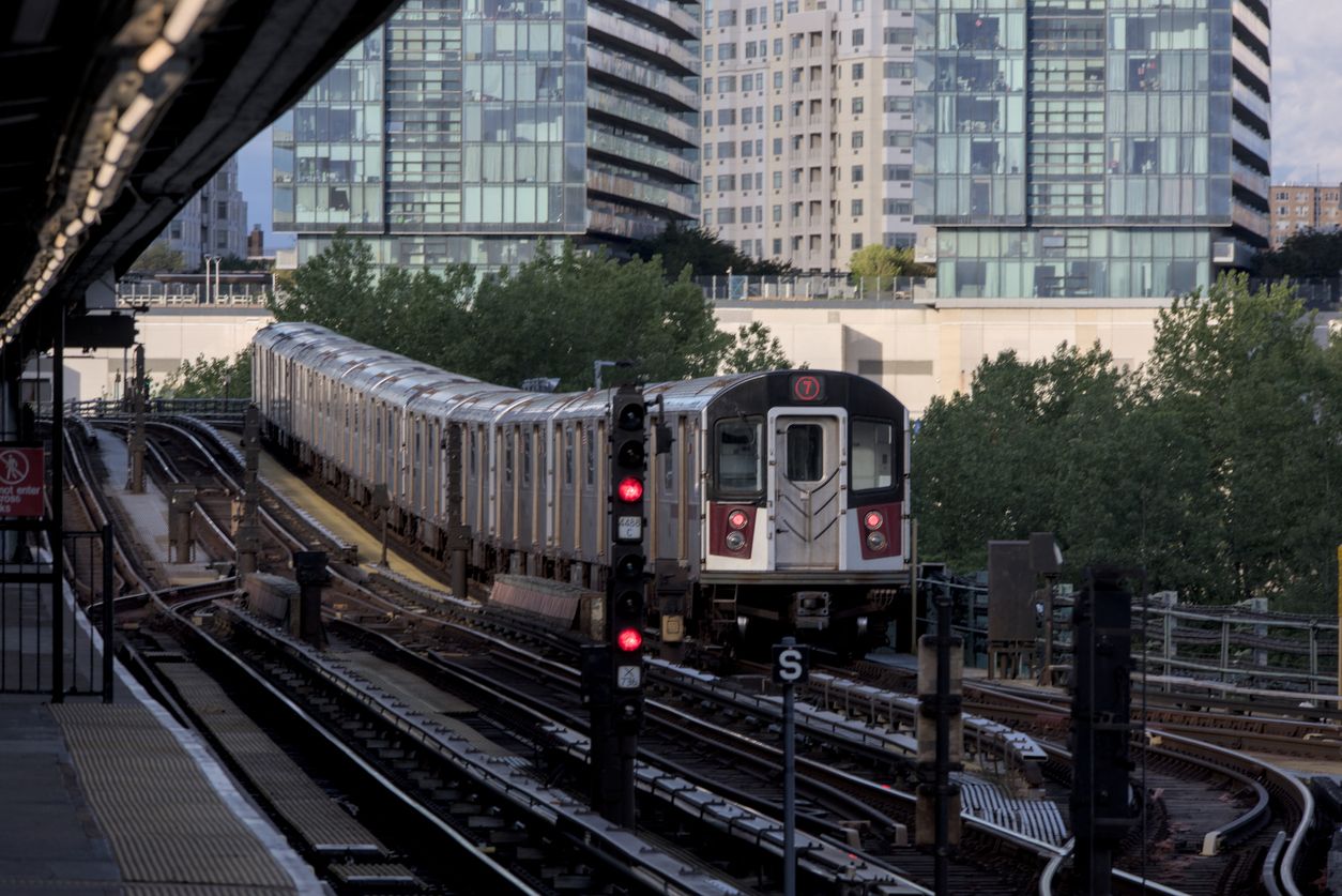 7 train running on above ground elevated tracks in Flushing, Queens, New York City