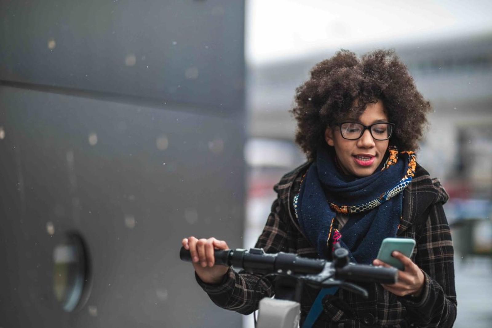 Woman using cellphone on rental fleet