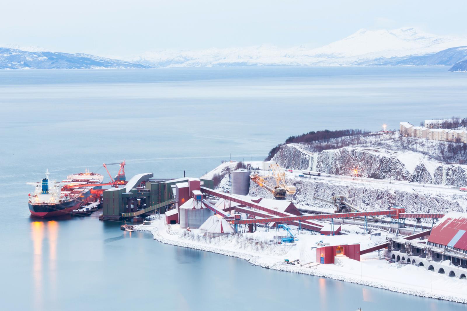 mining at norwegian port with cargo ship in winter