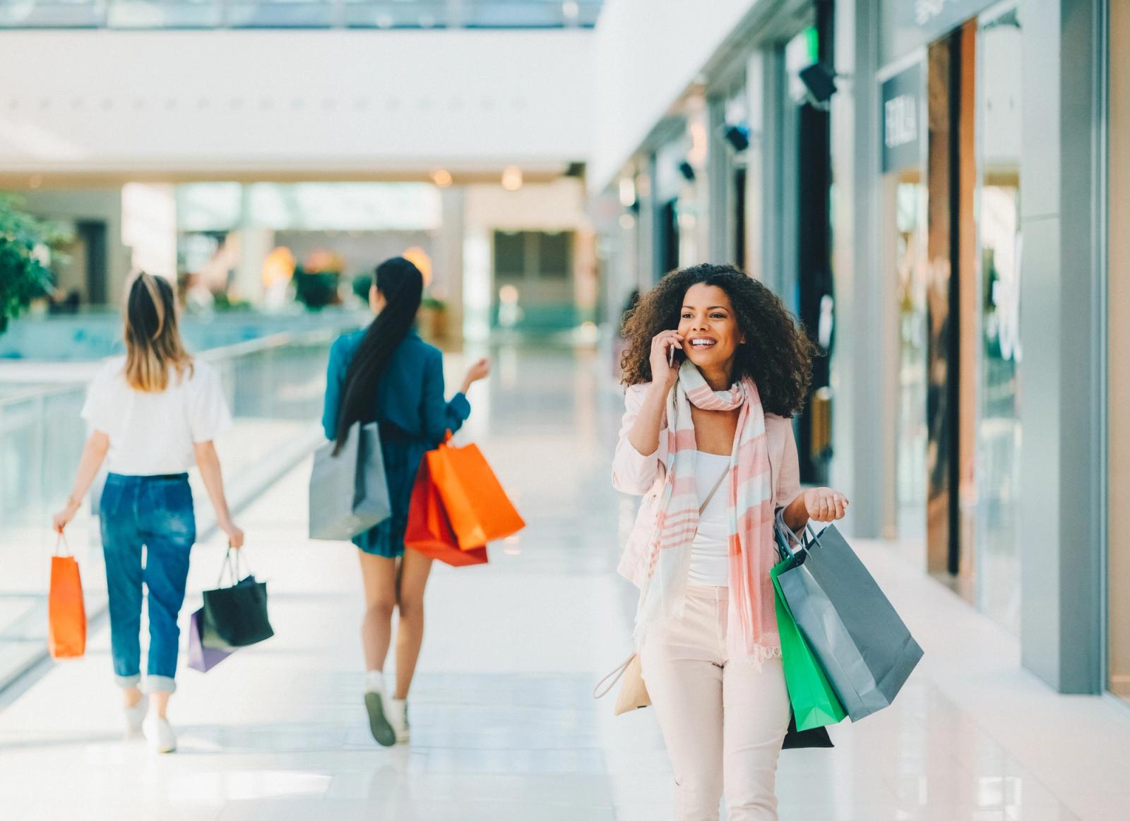 woman shopping in mall with bags