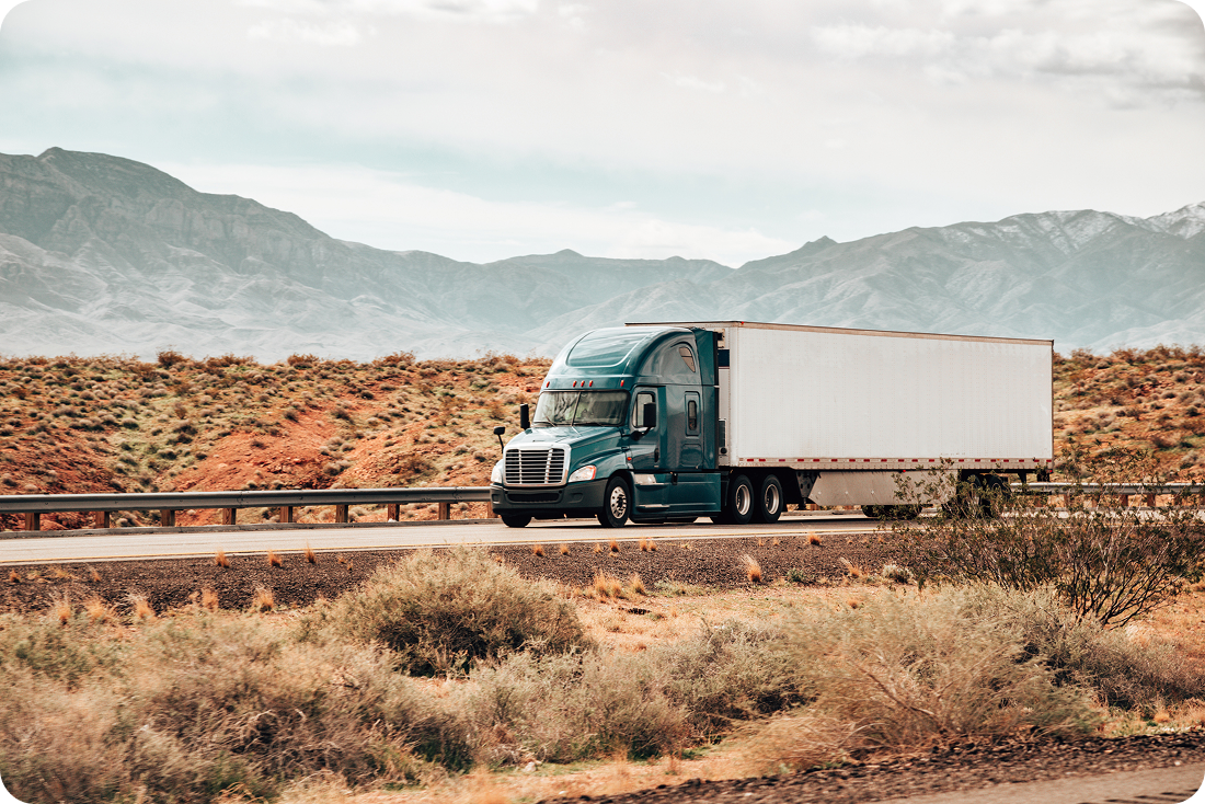 A long haul truck drives through the desert