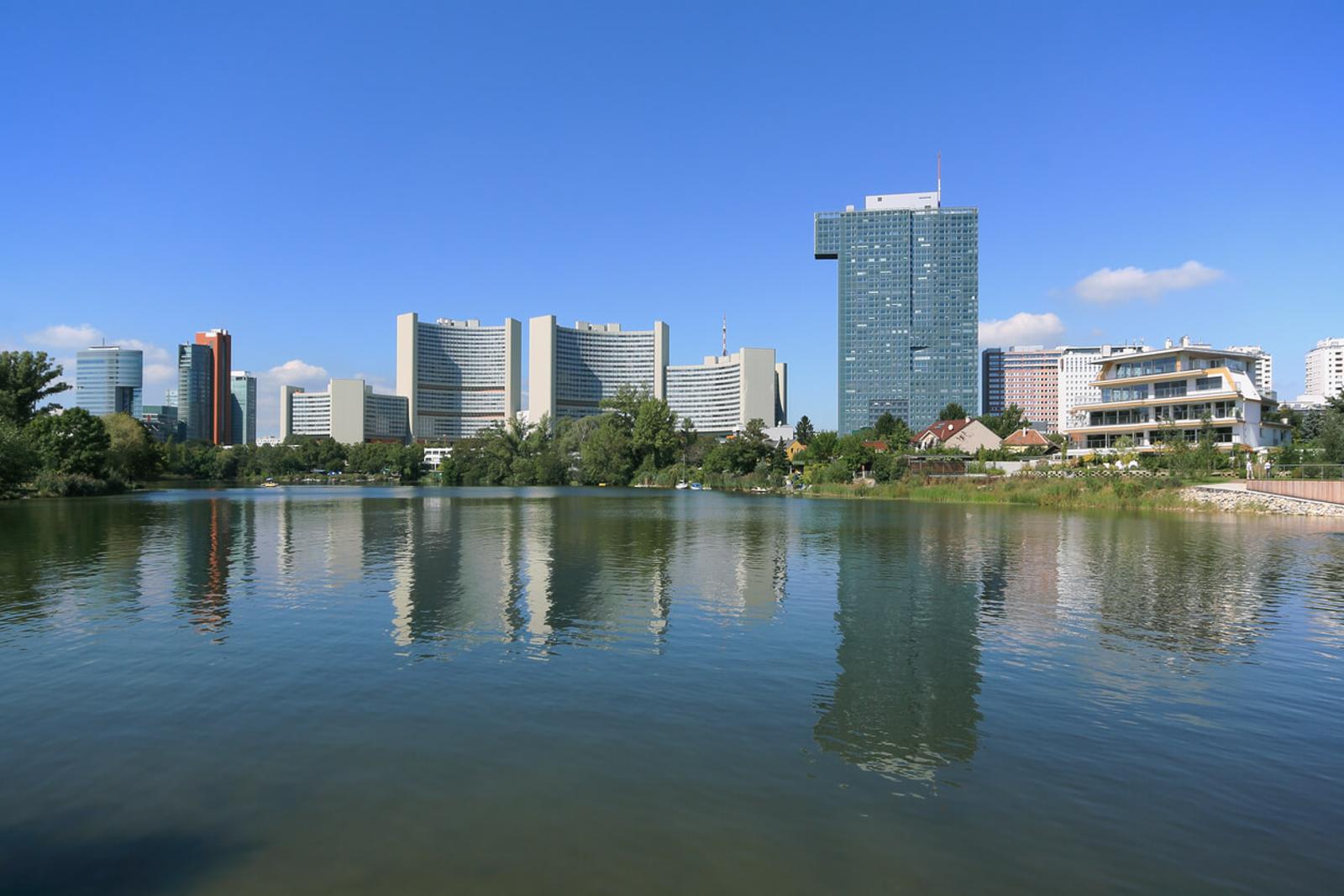 ienna International Centre (UNO City) reflecting in the calm water of Kaiserwasser