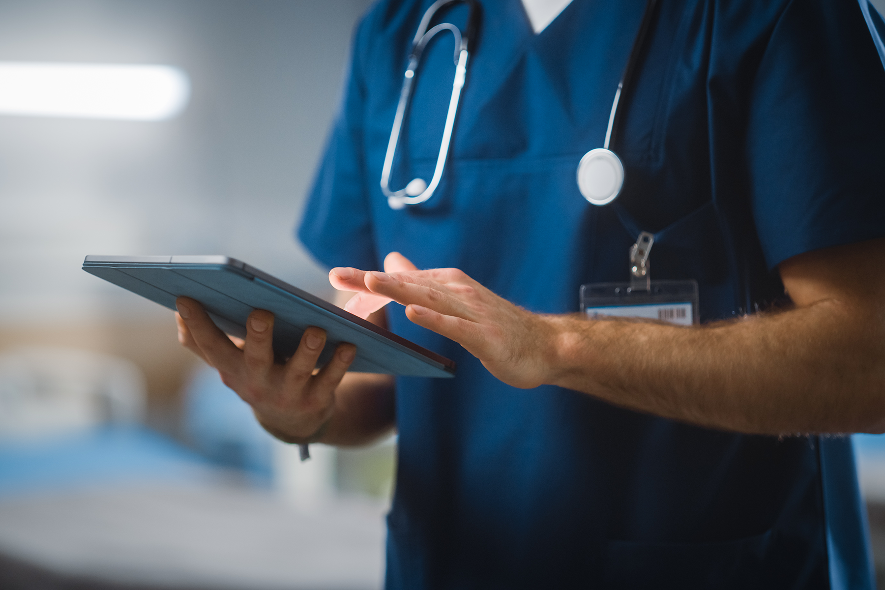 Healthcare worker checks tablet