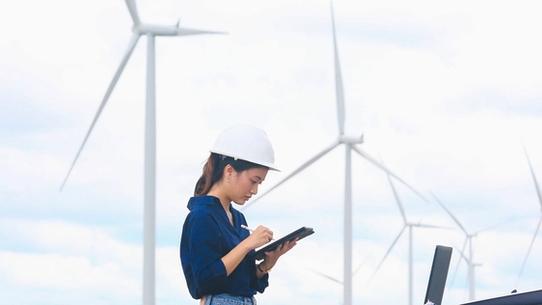 Woman analyzing smart wind turbines