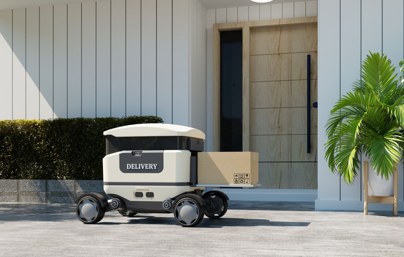 Delivery robot with a package outside a house front door