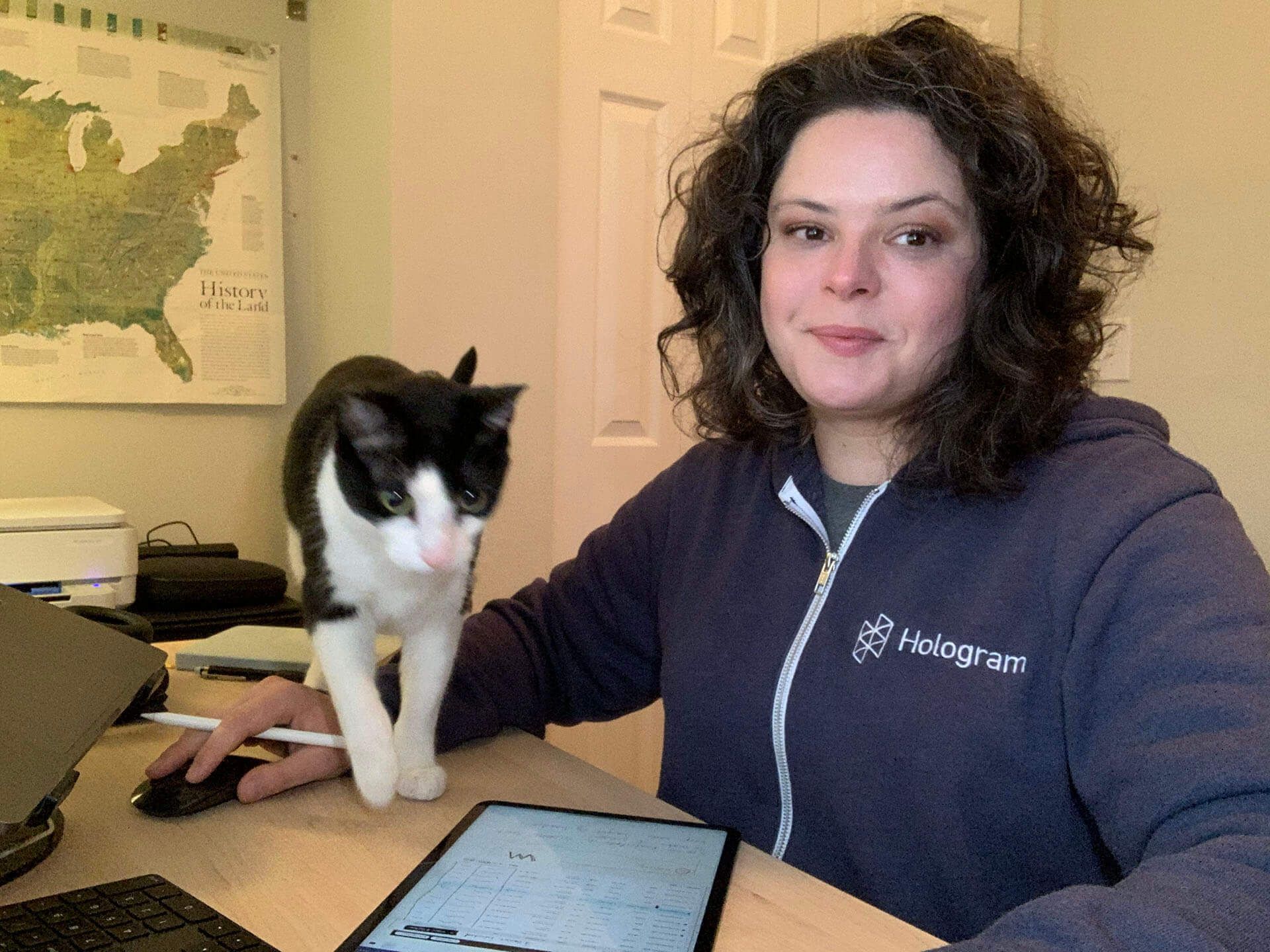 Hologram Product Designer Teresa Jimmerson works at her computer with her cat.