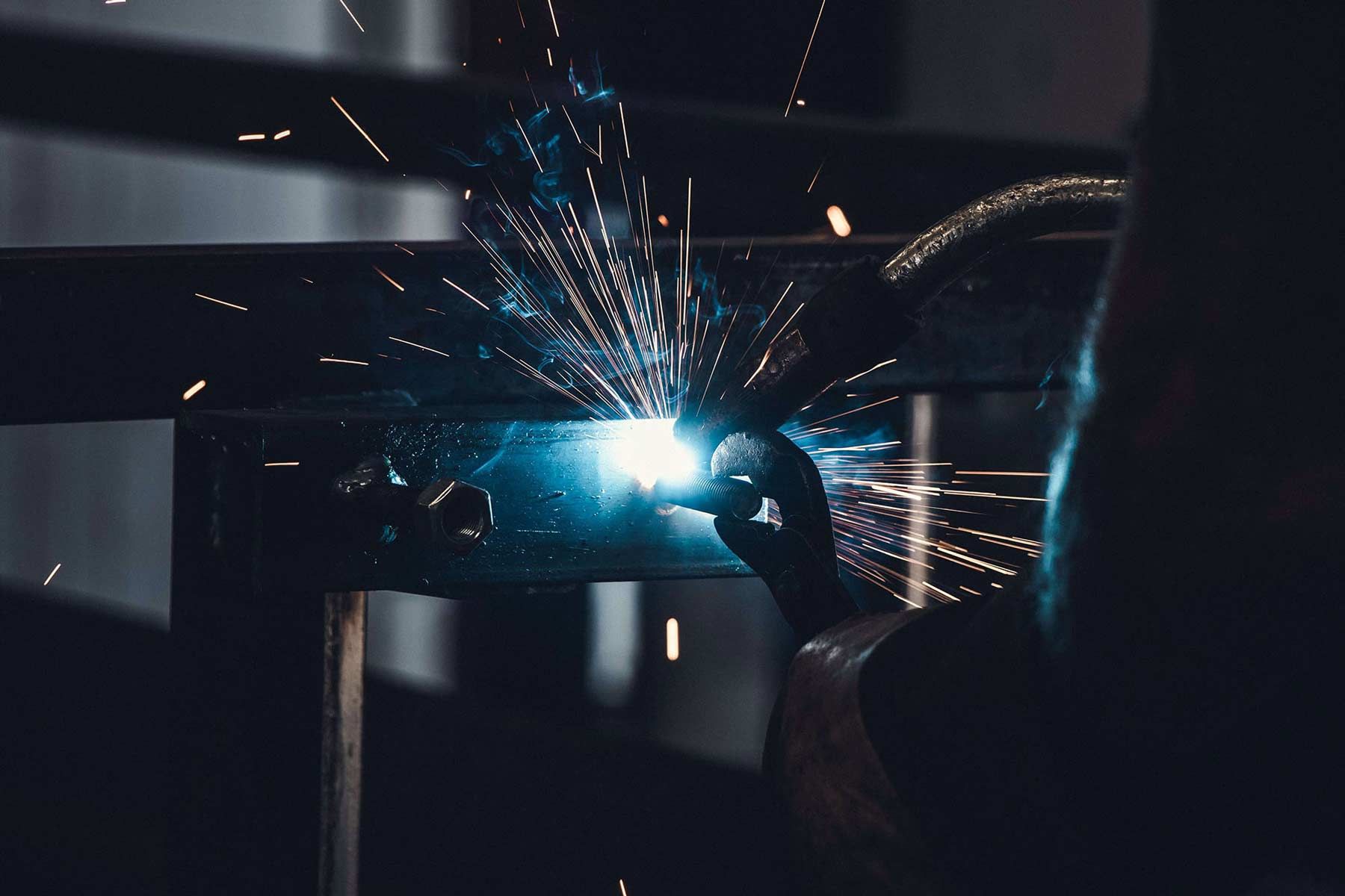 male metal worker welding metal in manufacturing