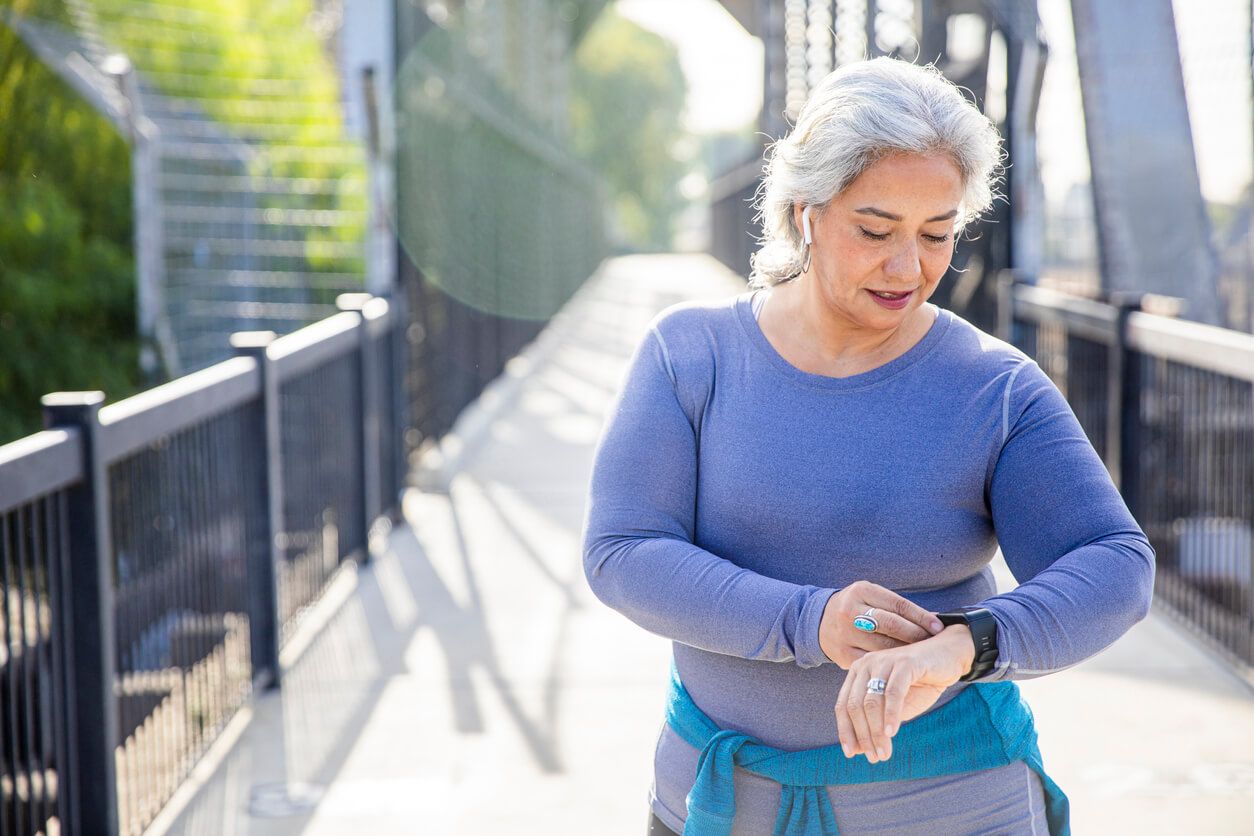 A woman checking her fitness tracker