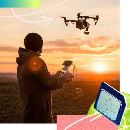 A person flies a drone outside in a field at sunset