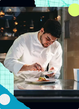 A chef is cooking in his restaurant's kitchen