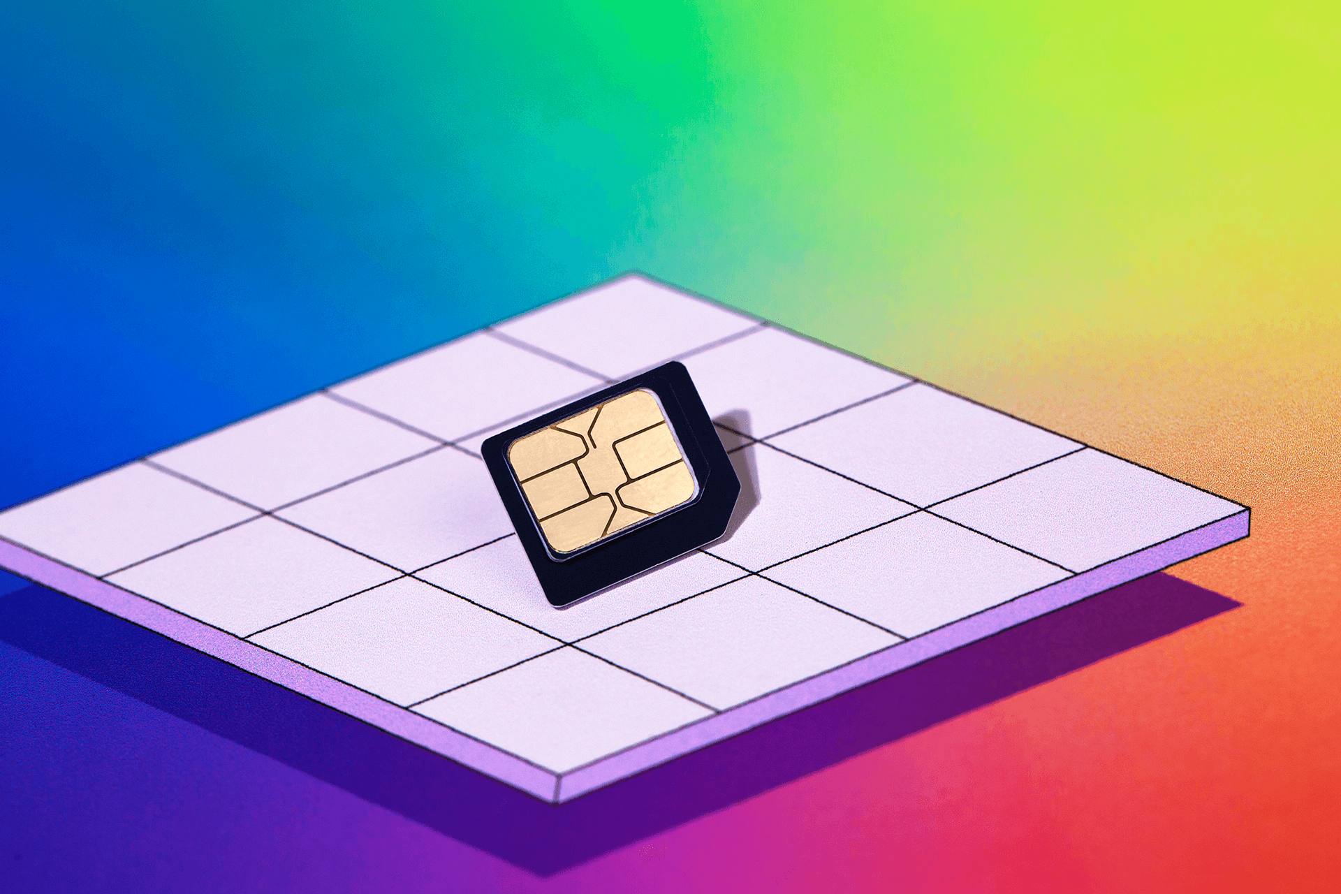 SIM card on a purple checkerboard with rainbow gradient in the background