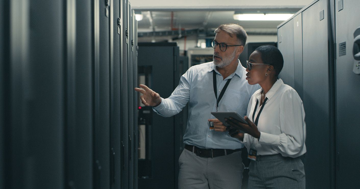 Team members check a server in a data center