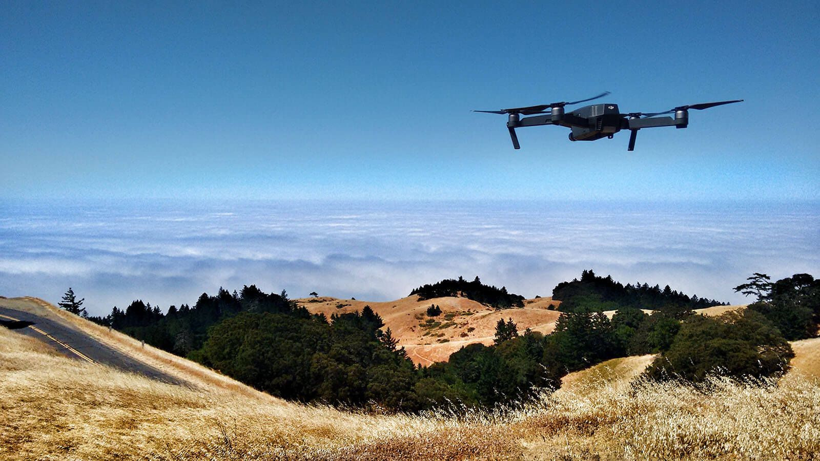 Drone flies over hills