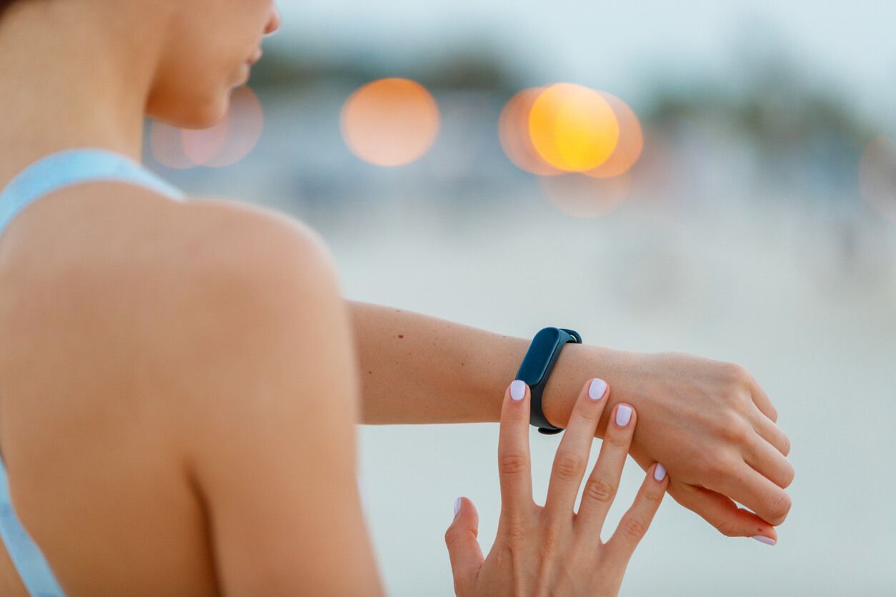 Female jogger checking the fitness tracker on her wrist