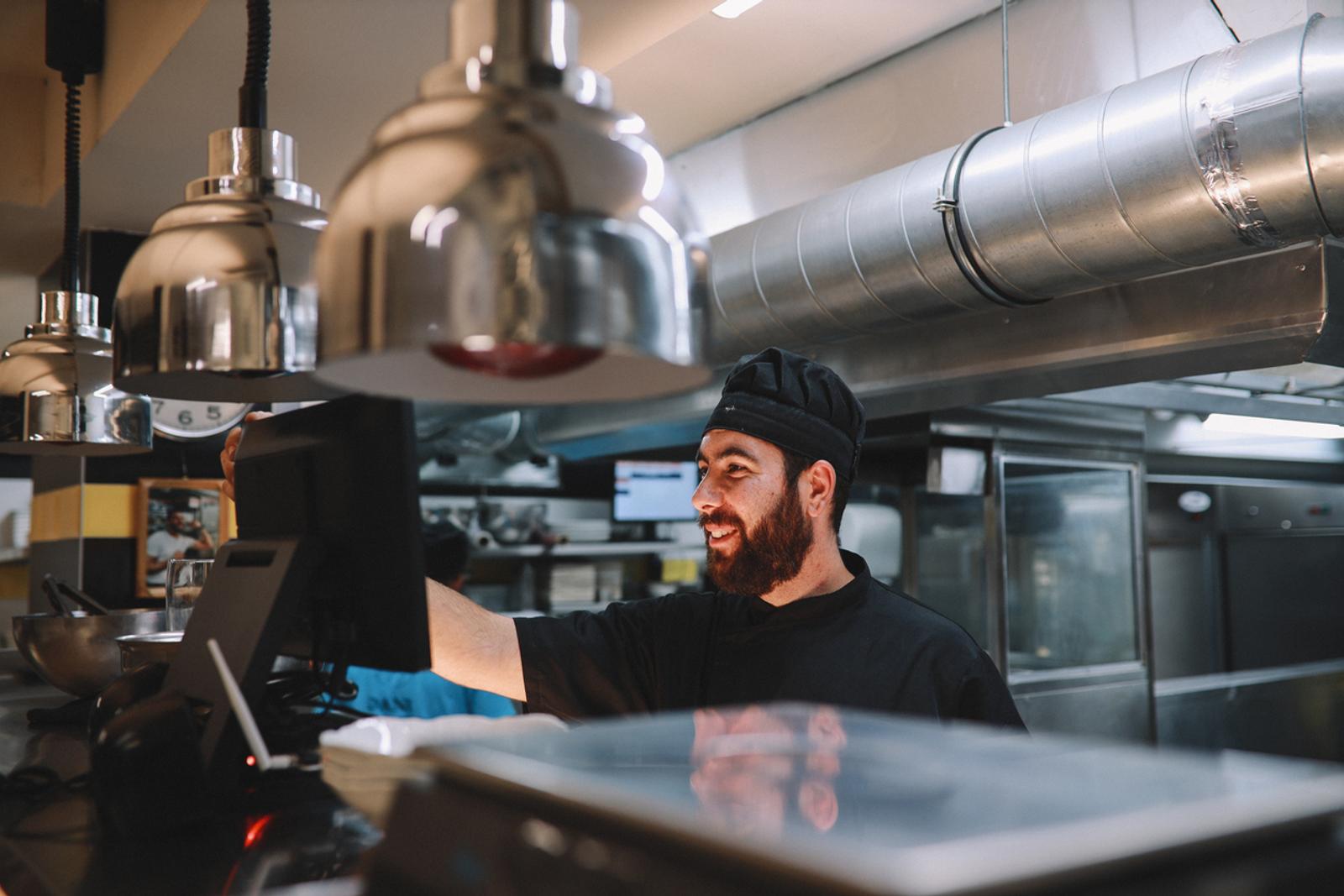 Cook receiving orders on a digital system