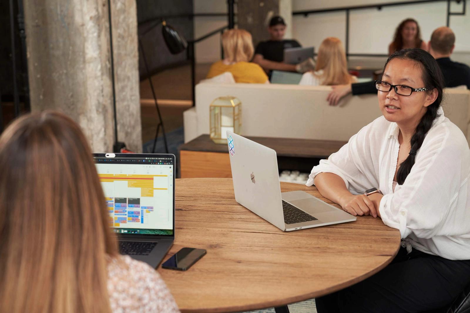 two women sitting at a conference table