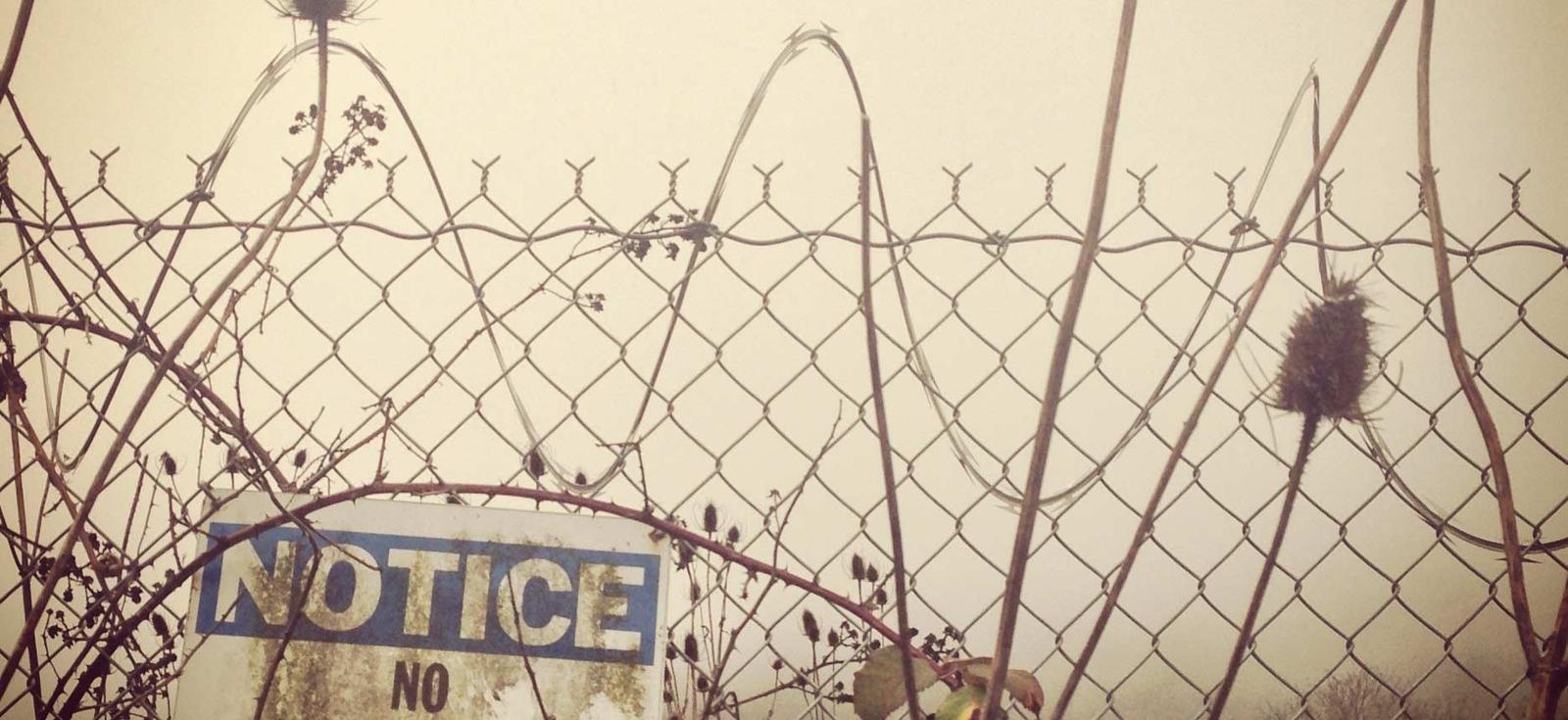 Fence with notice sign