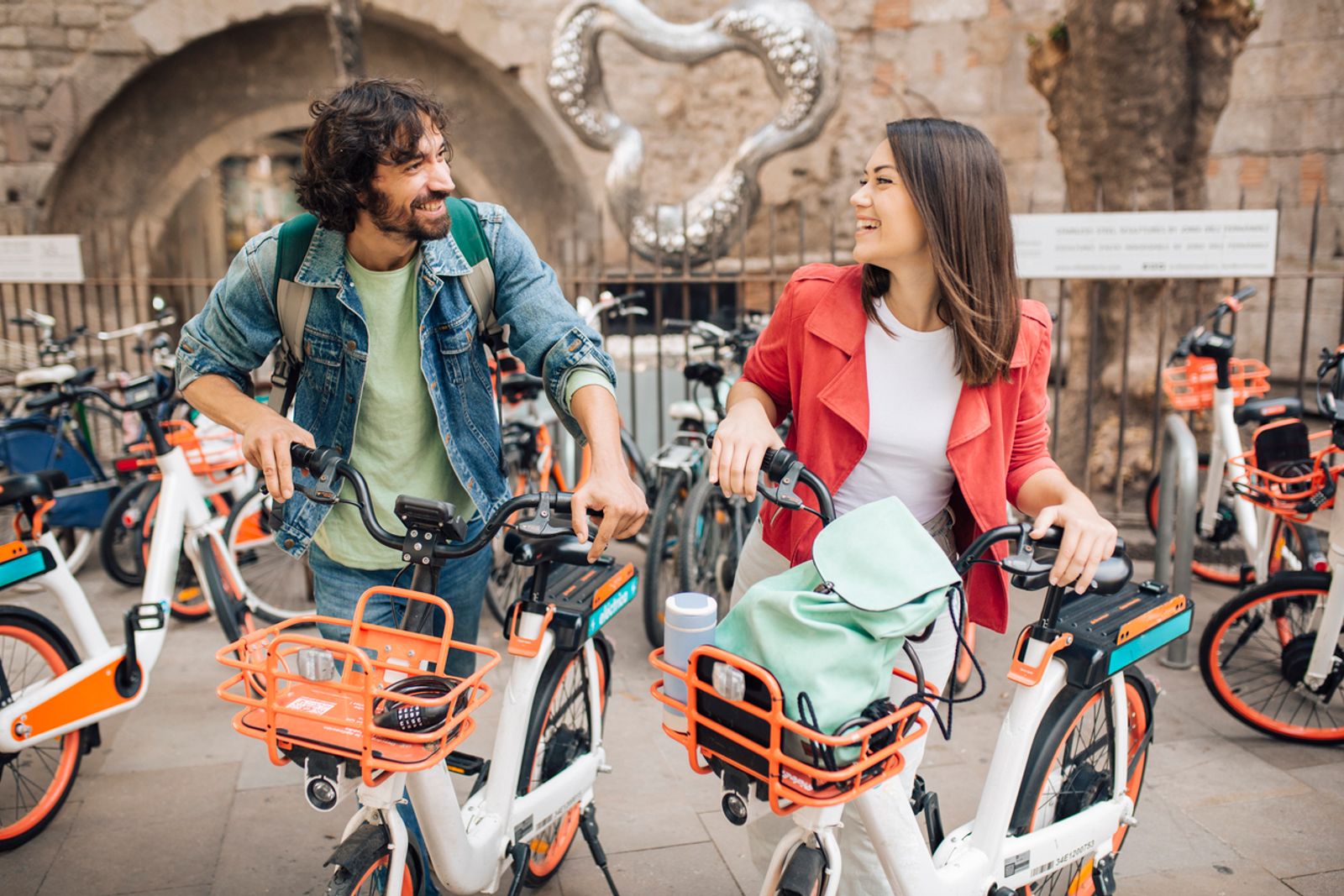 Two people on ebikes in city