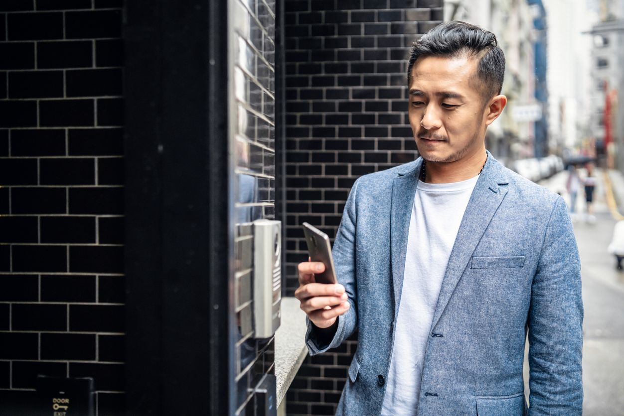 Man uses smartphone to unlock door