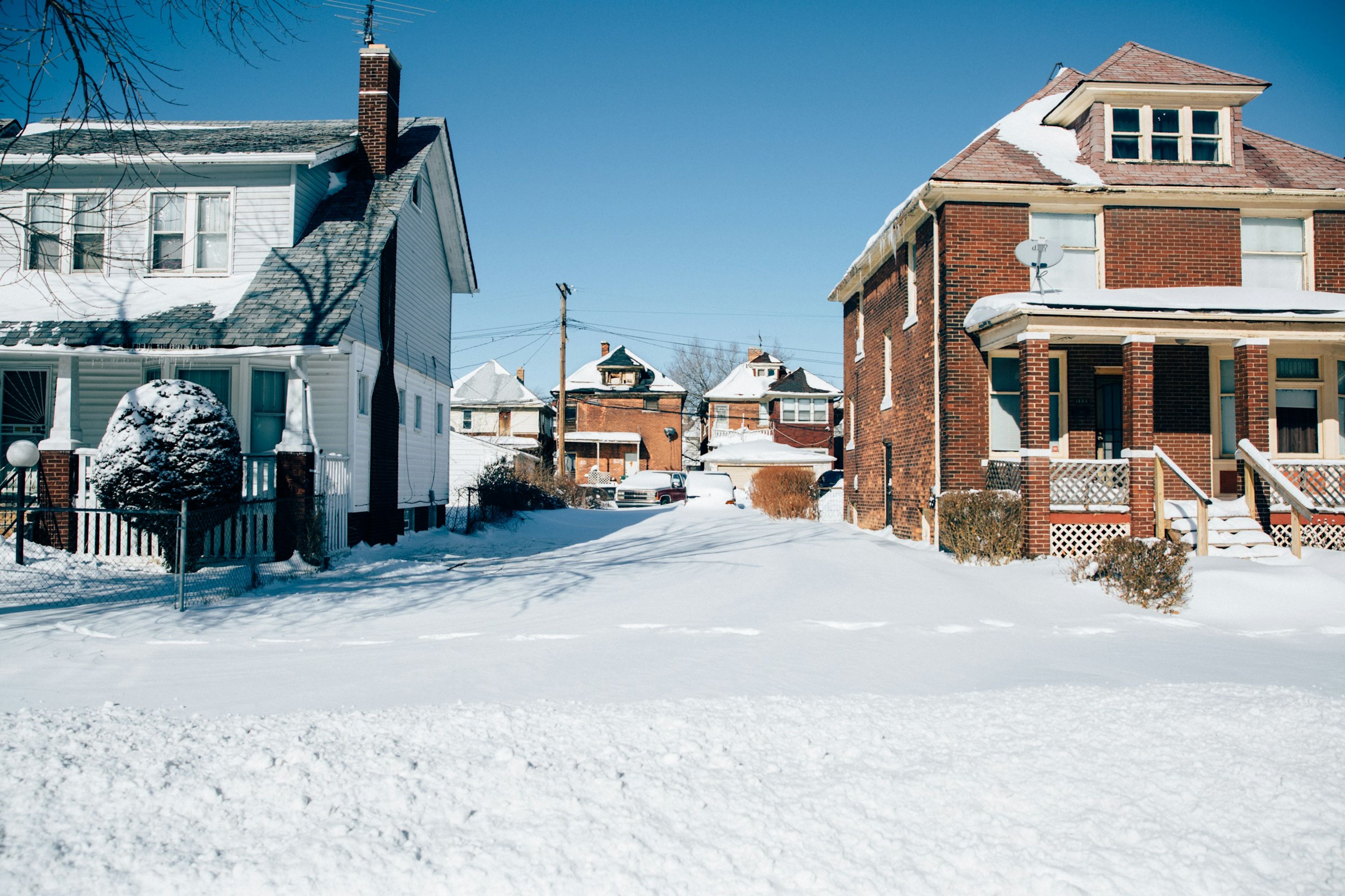Snow-covered street of brick houses