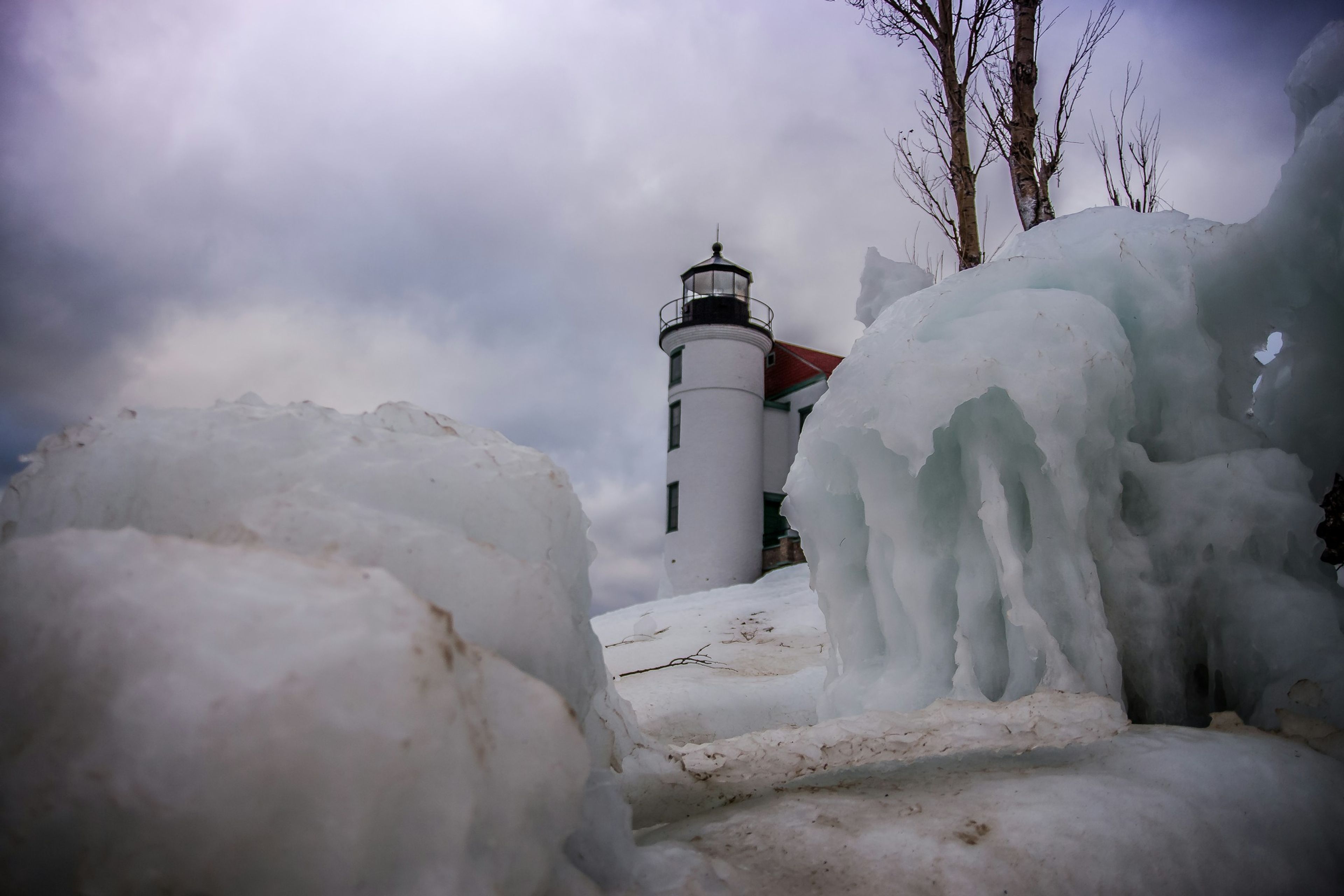 Lighthouse encased in ice on the lakeshore
