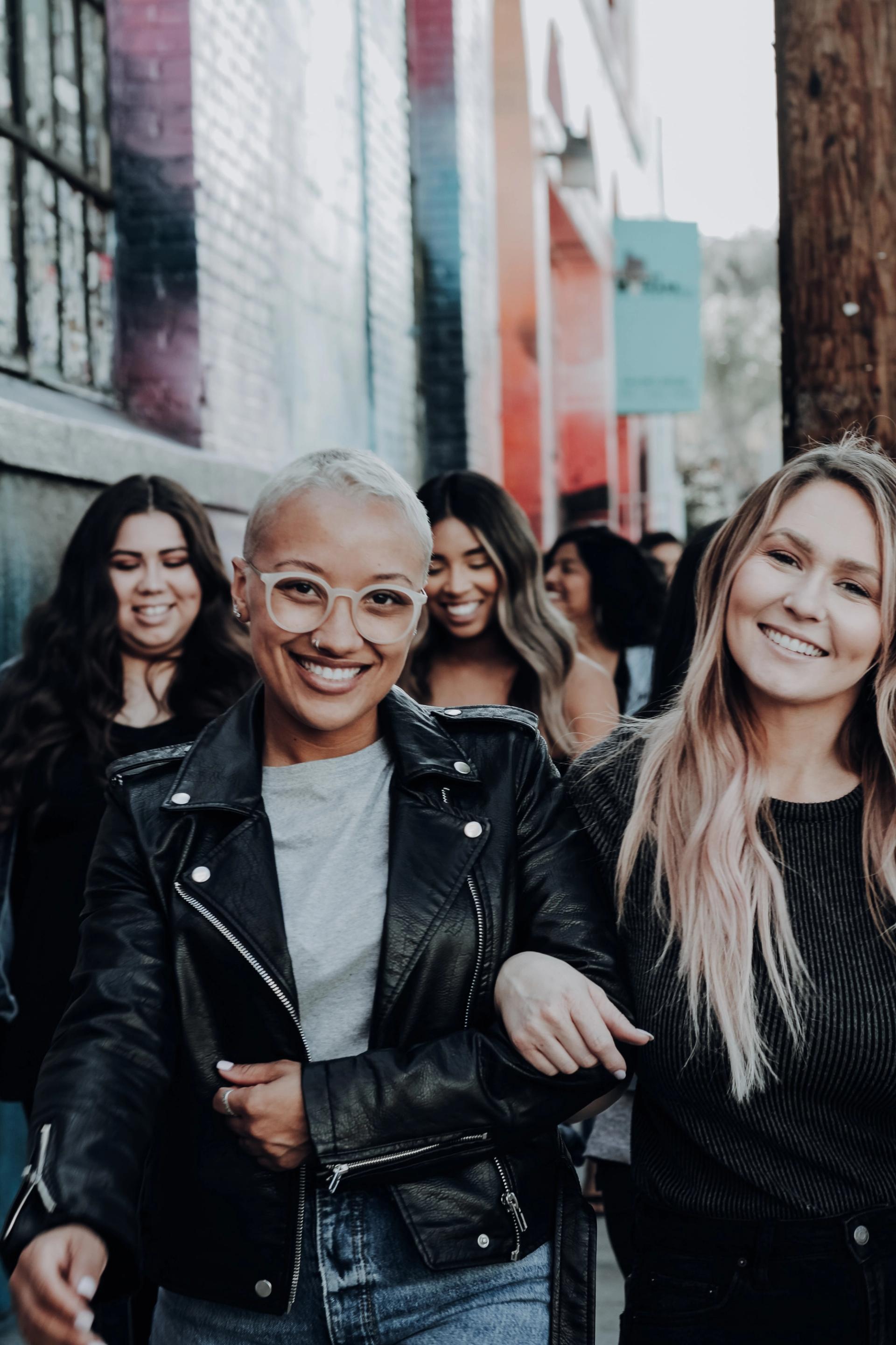 Group of diverse women smiling in street