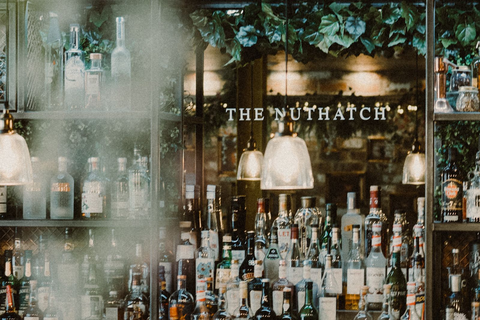 Friends sharing drinks around a table at The Nuthatch