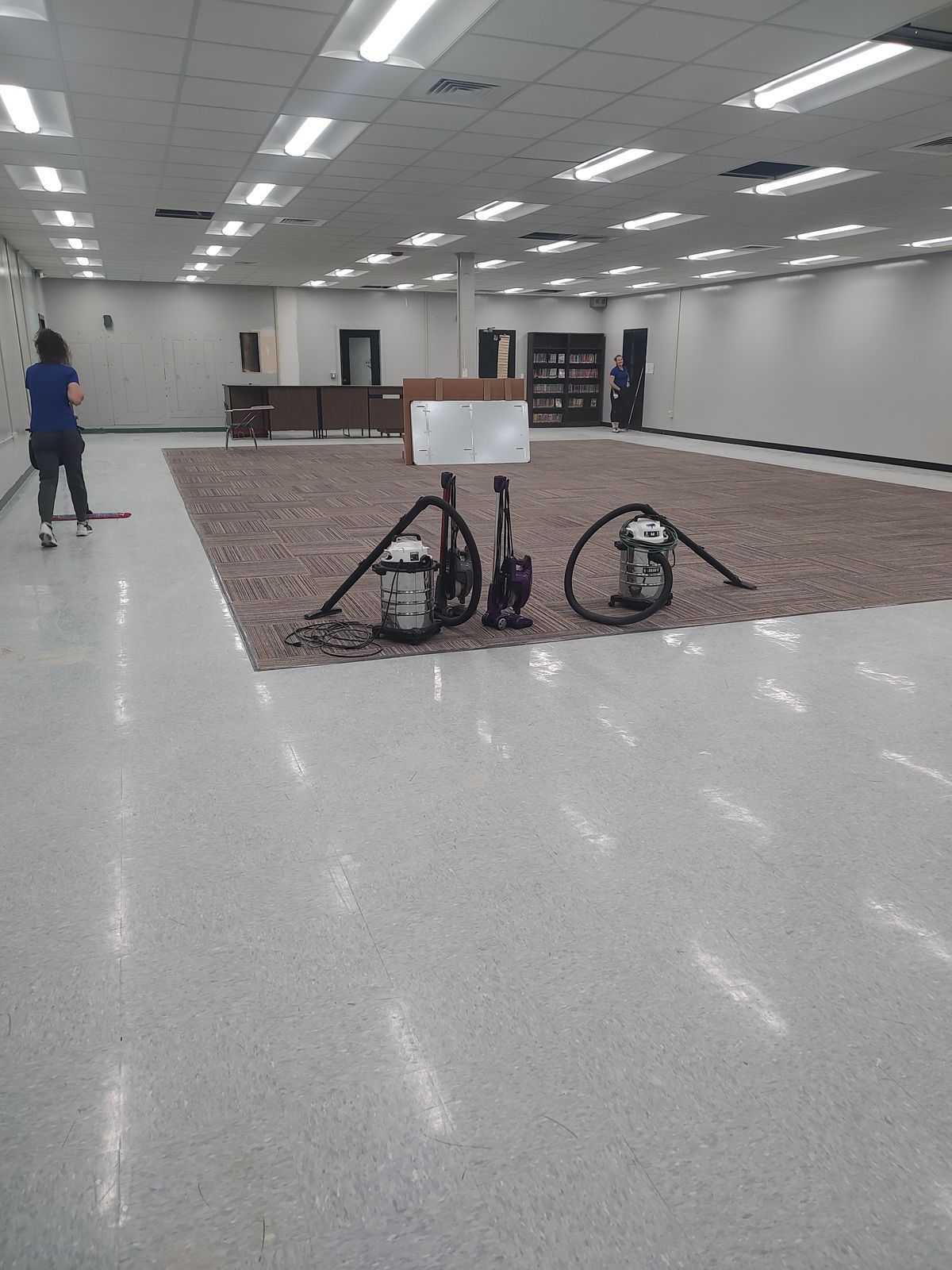 Crystal Clean crew member mopping a new school library during post-construction cleaning