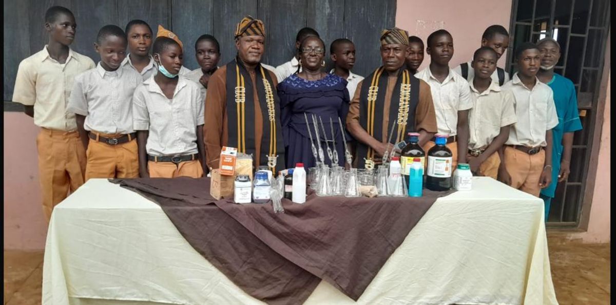 A commemorative group photograph featuring students, school administration, and Remolanders Social Club representatives alongside the newly donated laboratory materials.