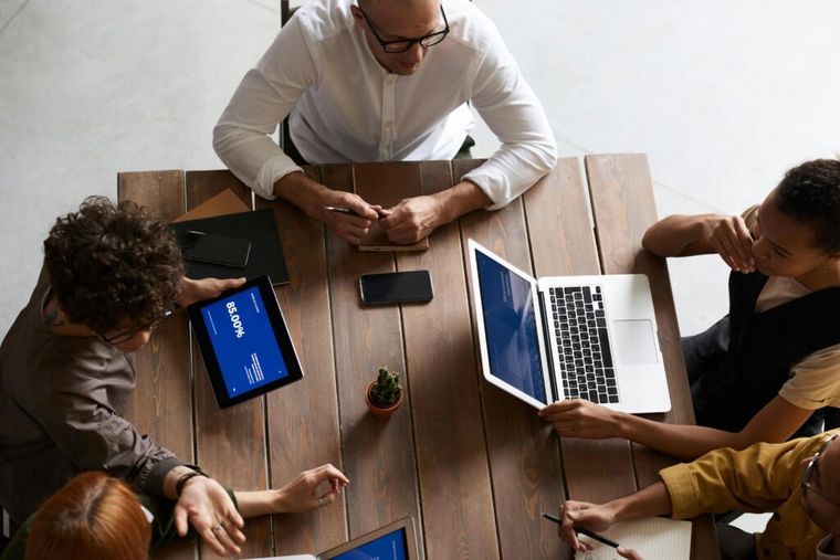 A top-view photo of a group of people gathered around a table.