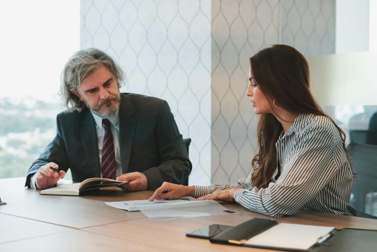 A group of professionals seated around a conference table—illustrating a collaborative discussion about structuring business exits and deferring capital gains taxes.