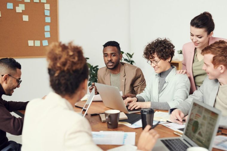 Image of tax professionals sat around a desk with their computers.