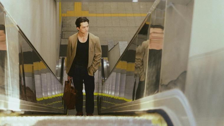 a man riding an escalator