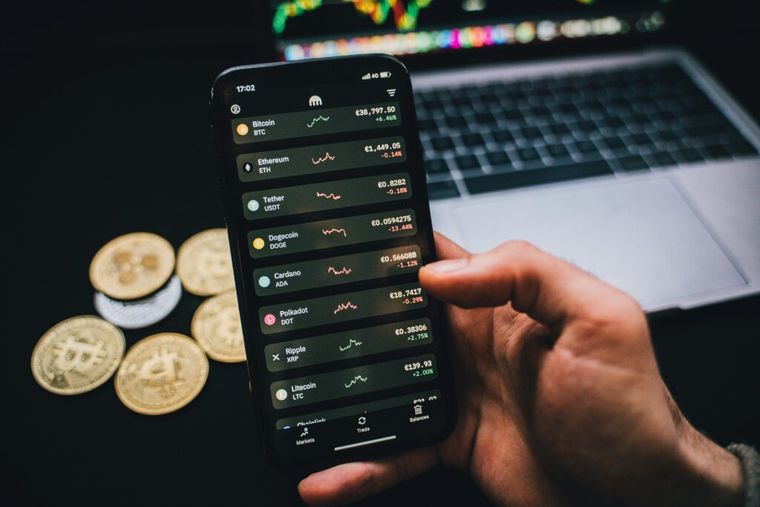 A person viewing cryptocurrency trading charts on a smartphone—illustrating how investors track performance and identify potential tax loss harvesting opportunities in a volatile digital asset market.
