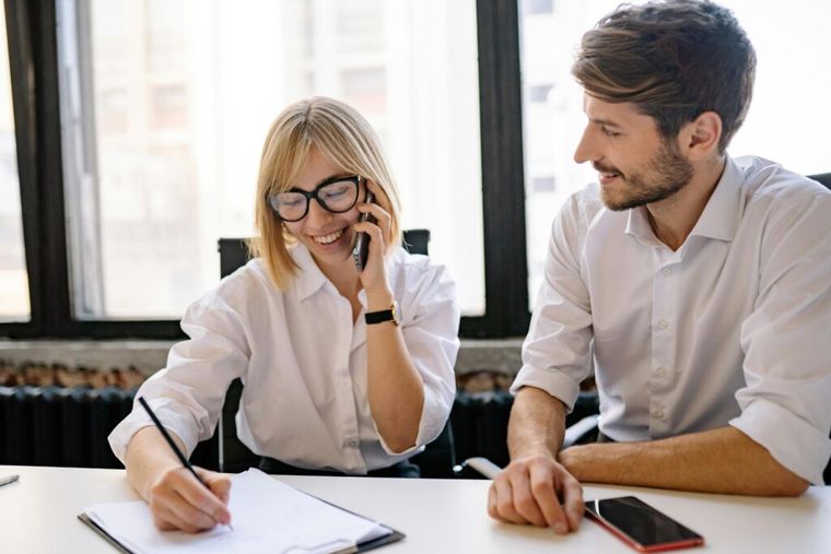 A tax advisor consulting with clients about 1031 exchange planning in a modern office.
