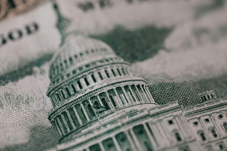 A close-up of an American banknote featuring a historic building—symbolizing federal estate tax laws and the financial implications of not leveraging estate tax exemption portability for married couples.