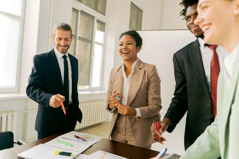 A group of working professionals engaged in joyful collaboration.