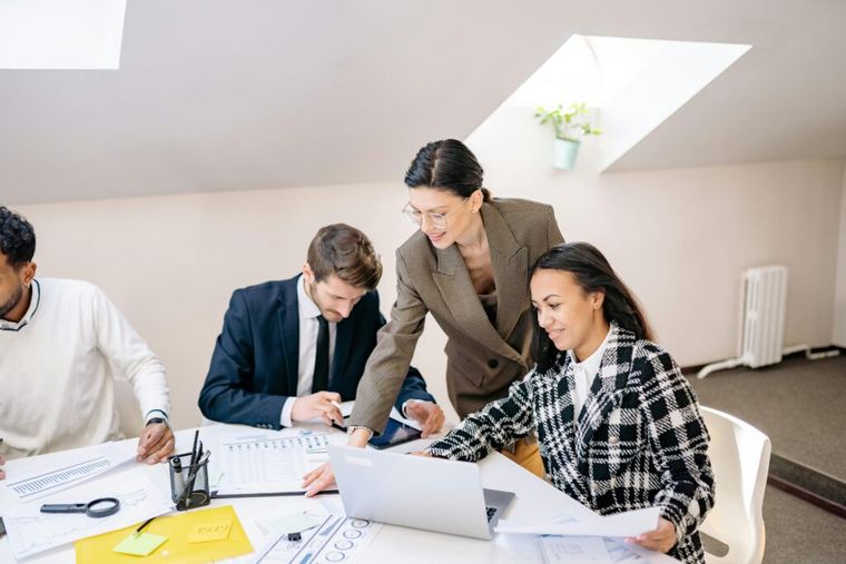 A group of professionals seated around a conference table—illustrating a collaborative discussion about structuring business exits and deferring capital gains taxes.