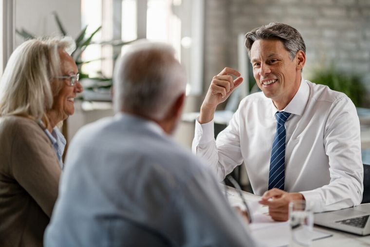 Image of two people talking to a tax advisor.