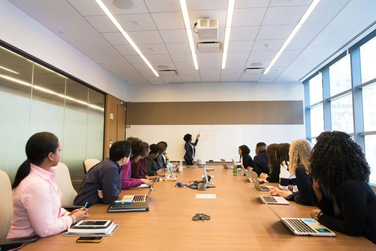 Image of a group of people in a conference room.